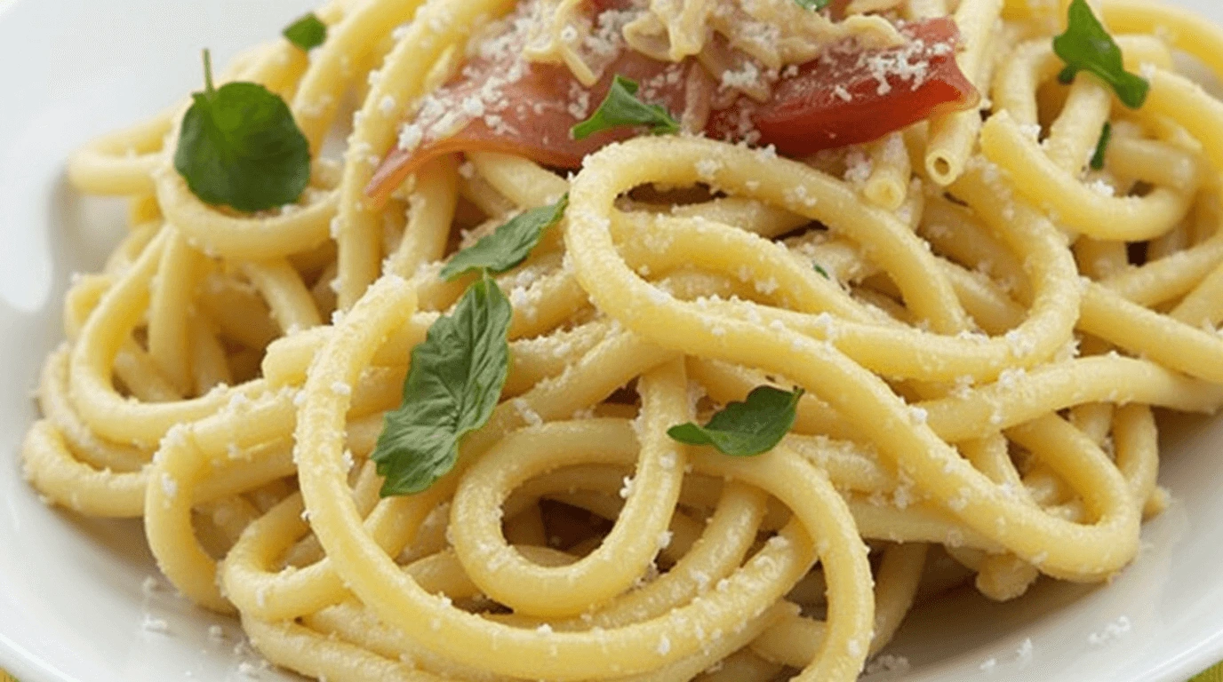 A creamy plate of pasta made with Boursin cheese, garnished with herbs and fresh vegetables.